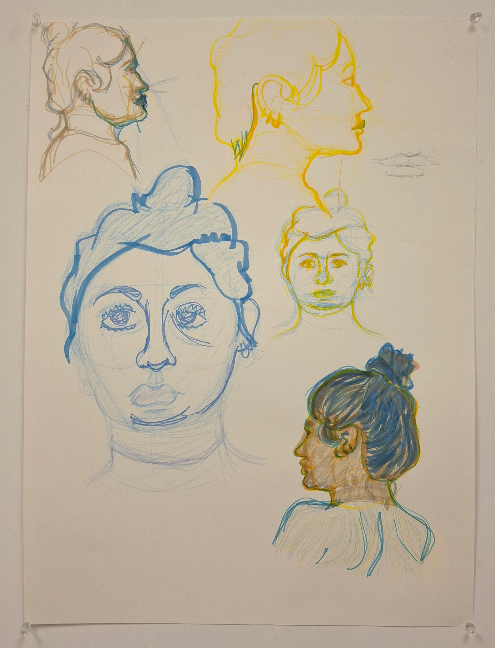 A photograph. It shows five busts done in colored pencil and marker along with a pencil sketch of lips off to the side. The paper is held up by thumb-tacks to the wall.